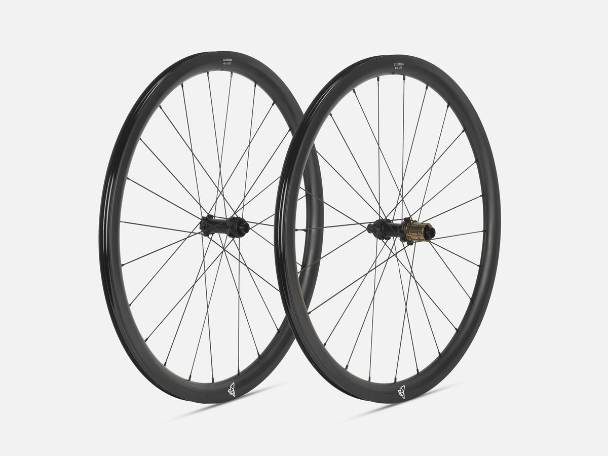 Two Litebike black carbon fiber road bicycle wheels with thin spokes, shown overlapping against a light gray background.