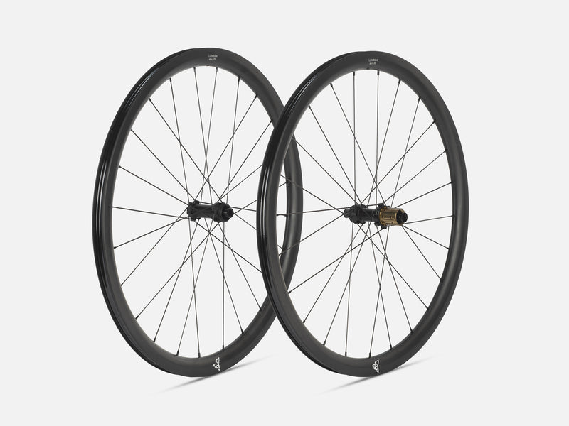 Two Litebike black carbon fiber road bicycle wheels with thin spokes, shown overlapping against a light gray background.