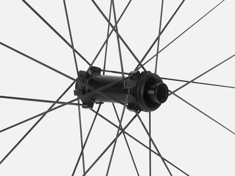 Close-up of Litebike Arc-35 carbon wheelset with a black bicycle wheel hub with thin black spokes radiating against a light gray background.